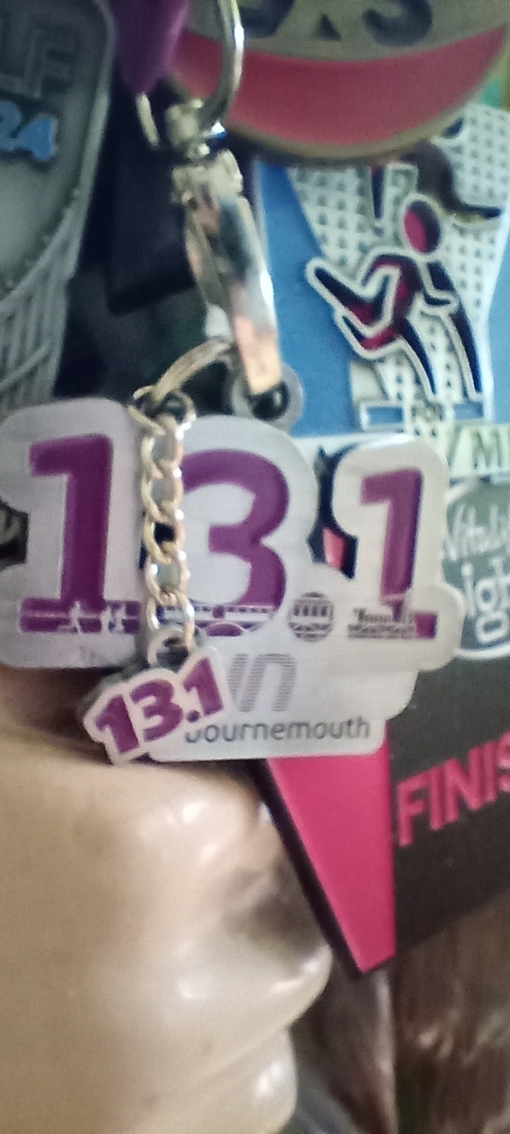 A medal with the text "13.1 Bournemouth" is shown with a blurred background.