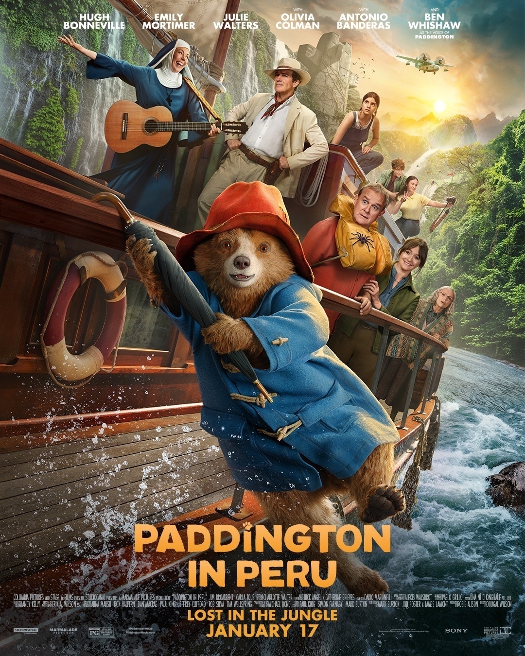 A bear wearing a red hat and blue coat is hanging from a boat filled with various people journeying through a jungle river, with the text "Paddington in Peru" prominently displayed.